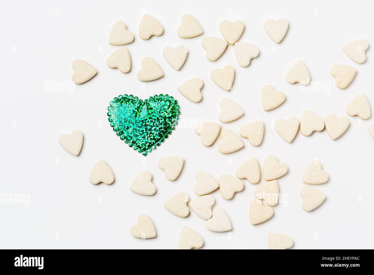 Heart-shaped little sweet cookies  on white background, minimalistic saint valentine`s day greeting card Stock Photo